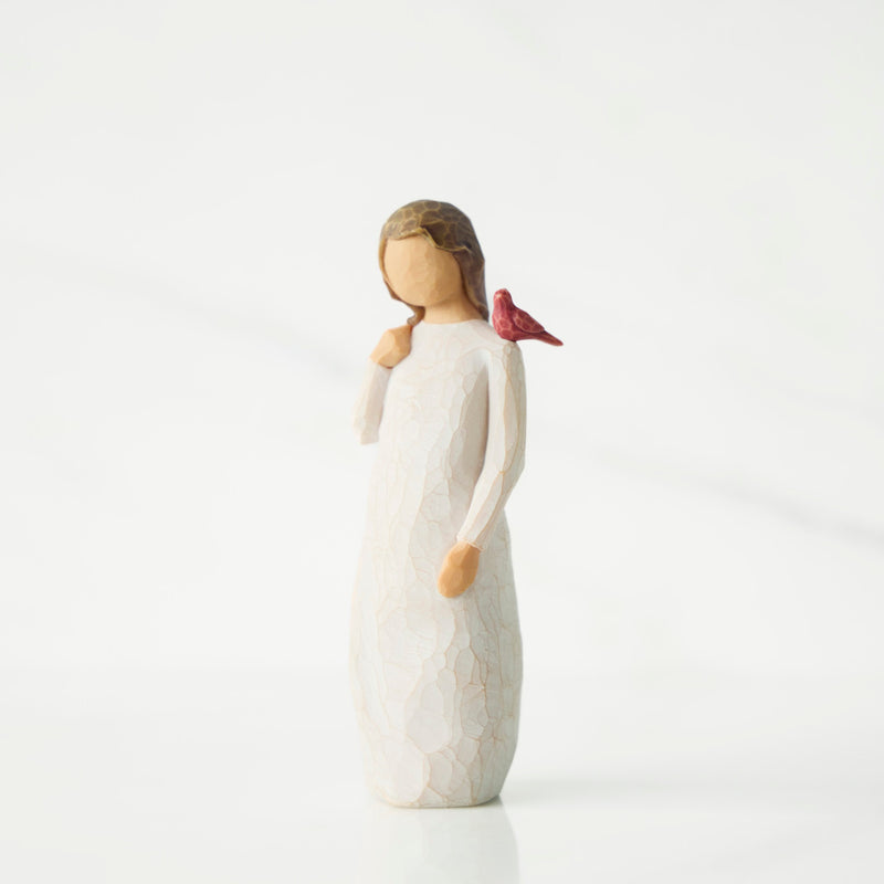 Small figurine with red cardinal on shoulder